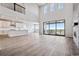 A modern living room boasts a spacious layout, an abundance of natural light, and stylish wood flooring at 13710 Emerald Lake St, Parker, CO 80138