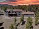 Aerial view of this beautiful home showcasing the surrounding mature trees at 32091 Black Widow Dr, Conifer, CO 80433