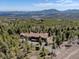 Expansive aerial view of a home surrounded by lush green forest and mountain views at 32091 Black Widow Dr, Conifer, CO 80433