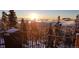 A scenic winter landscape from the backyard showcasing a view above the clouds at sunset at 32091 Black Widow Dr, Conifer, CO 80433