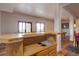 Basement bar featuring wood counters, bar fridge and easy access to pool table and views at 32091 Black Widow Dr, Conifer, CO 80433