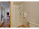 Clean and simple bathroom with a shower stall and a view into an adjacent room at 32091 Black Widow Dr, Conifer, CO 80433