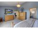 Comfortable bedroom featuring carpeted floors, a large dresser, and television at 32091 Black Widow Dr, Conifer, CO 80433