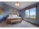 Cozy bedroom with a large window, providing scenic views and natural light at 32091 Black Widow Dr, Conifer, CO 80433