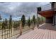 Expansive outdoor deck boasting scenic views, offering an ideal space for relaxation and entertaining guests in a tranquil setting at 32091 Black Widow Dr, Conifer, CO 80433