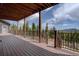 Open wood deck overlooking peaceful mountain scenery offers ample space, ideal for outdoor living and relaxing under a covered patio at 32091 Black Widow Dr, Conifer, CO 80433