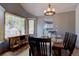 Cozy dining area with natural light, showcasing a window view and an adjacent kitchen at 32091 Black Widow Dr, Conifer, CO 80433