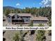Stunning mountain home featuring a spacious deck and views of a lush, tree-filled landscape at 32091 Black Widow Dr, Conifer, CO 80433
