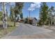 Scenic view of a home nestled among trees, accessible by a long driveway, offering privacy and charm at 32091 Black Widow Dr, Conifer, CO 80433