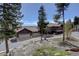 Charming multi-story home featuring a three car garage and mature landscaping at 32091 Black Widow Dr, Conifer, CO 80433
