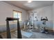 A home gym featuring various exercise machines, rubber floors, and a window for natural light, creating a functional workout space at 32091 Black Widow Dr, Conifer, CO 80433