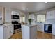 Bright kitchen features white cabinets, stainless steel appliances, and an island at 32091 Black Widow Dr, Conifer, CO 80433