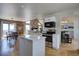 Modern kitchen with stainless steel appliances, an island, and an adjacent dining area at 32091 Black Widow Dr, Conifer, CO 80433