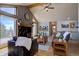 Inviting living room features a fireplace, vaulted ceilings with wood beams, and abundant natural light at 32091 Black Widow Dr, Conifer, CO 80433