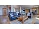 Open-concept living room with hardwood floors, modern lighting, and comfortable seating at 32091 Black Widow Dr, Conifer, CO 80433