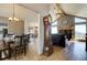 Inviting living spaces featuring wood floors, a fireplace, and vaulted ceilings, creating a warm atmosphere at 32091 Black Widow Dr, Conifer, CO 80433