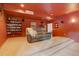 Home theater room with large sofa, shelving, carpeted floors, a warm ambiance and plenty of room for entertaining at 32091 Black Widow Dr, Conifer, CO 80433