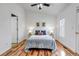 Bedroom featuring natural light, wood flooring, and neutral walls with coordinated decor at 5075 Garrison St # 2, Wheat Ridge, CO 80033