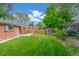 A spacious backyard features a lush lawn, shed, and mature trees, offering a private outdoor retreat at 10784 Allendale Dr, Arvada, CO 80004