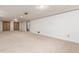 This finished basement area offers neutral carpet and paint and access to the utility room at 10784 Allendale Dr, Arvada, CO 80004