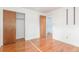 This bedroom has hardwood floors, a closet, and ample natural light at 10784 Allendale Dr, Arvada, CO 80004