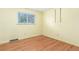 Bedroom with hardwood floors, window, and yellow walls at 10784 Allendale Dr, Arvada, CO 80004