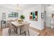 Modern dining room featuring a contemporary table setting, stylish decor, and natural light creating an elegant ambiance at 10784 Allendale Dr, Arvada, CO 80004