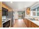 Bright kitchen featuring stainless steel appliances, wood cabinets, and plenty of counter space for meal preparation at 10784 Allendale Dr, Arvada, CO 80004