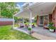 A backyard covered patio featuring outdoor seating and greenery at 10784 Allendale Dr, Arvada, CO 80004