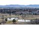 Scenic aerial view of community features a beautiful golf course, reflecting ponds, and city skyline at 178 E 11Th Ave, Broomfield, CO 80020