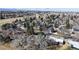 Aerial view of a residential neighborhood with mature trees and a glimpse of a nearby lake at 178 E 11Th Ave, Broomfield, CO 80020