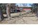Expansive backyard with a red brick home, complemented by mature trees, offers ample space for outdoor activities at 178 E 11Th Ave, Broomfield, CO 80020