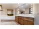 Bright bathroom featuring a large mirror with Hollywood lights, a soaking tub, and classic wooden cabinets at 178 E 11Th Ave, Broomfield, CO 80020