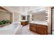 Bright bathroom featuring dual vanities, large mirrors with Hollywood lights, and a luxurious soaking tub at 178 E 11Th Ave, Broomfield, CO 80020