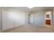 Bedroom with closet and ensuite bath, featuring patterned wallpaper and neutral carpet at 178 E 11Th Ave, Broomfield, CO 80020