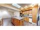View of kitchen with stone floors, an island, and wooden cabinets, illuminated by a skylight at 178 E 11Th Ave, Broomfield, CO 80020