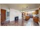 Spacious kitchen area with stone floors, wooden cabinets, kitchen island, and white brick wall at 178 E 11Th Ave, Broomfield, CO 80020