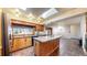 Bright kitchen featuring a large island, skylights, and wood cabinets, perfect for culinary enthusiasts at 178 E 11Th Ave, Broomfield, CO 80020