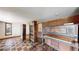 Room features vintage display cases, a classic piano, and patterned flooring, blending functionality with character at 178 E 11Th Ave, Broomfield, CO 80020