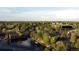 Aerial view of 10158 E Fair Circle and the surrounding neighborhood featuring mature trees and a lake at 10158 E Fair Cir, Englewood, CO 80111