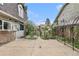 This property features an outdoor living space with stone pavers and landscaped features at 10158 E Fair Cir, Englewood, CO 80111