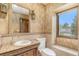 Lavish bathroom featuring an ornate vanity with granite counters and decorative walls at 10158 E Fair Cir, Englewood, CO 80111