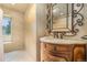 Elegant bathroom with decorative vanity, ornate mirror, and tile flooring at 10158 E Fair Cir, Englewood, CO 80111