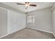 Simple bedroom with carpeted floors, closet, ceiling fan, and a window at 10158 E Fair Cir, Englewood, CO 80111