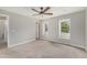Neutral bedroom features carpet, a ceiling fan, two windows, and a closet at 10158 E Fair Cir, Englewood, CO 80111