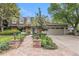 Charming home featuring manicured landscaping, brick accents, and a two-car garage at 10158 E Fair Cir, Englewood, CO 80111