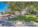 Well-maintained home exterior featuring a lush lawn, mature trees, and a two-car garage at 10158 E Fair Cir, Englewood, CO 80111