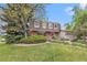 Attractive home exterior showcasing a lush lawn and mature trees at 10158 E Fair Cir, Englewood, CO 80111