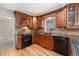 Beautiful kitchen with wooden cabinets, granite counters, and black appliances at 10158 E Fair Cir, Englewood, CO 80111