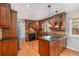 Gourmet kitchen with stainless steel appliances, custom cabinets, and granite countertops at 10158 E Fair Cir, Englewood, CO 80111
